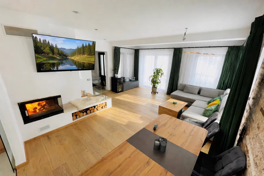 Panoramic living room with sofa bed and wall-mounted TV